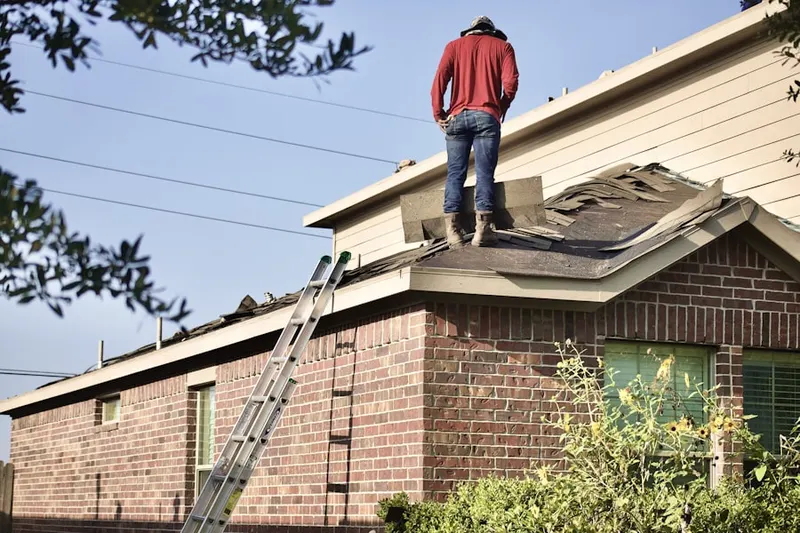 Professional roofer working on a residential roof in Floral Park